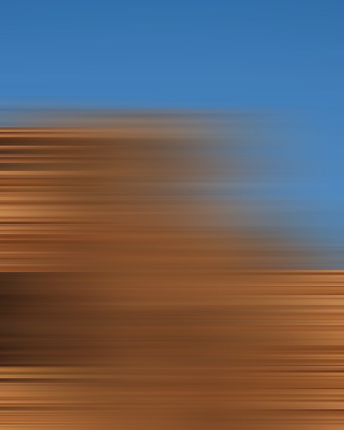 An abstract motion blur in blue and sand