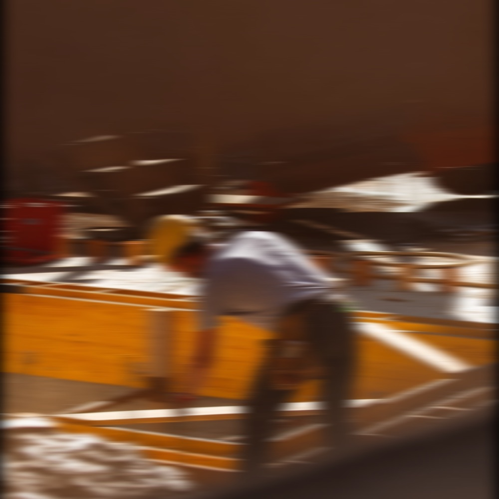 Workers loading cartons in a warehouse, motion blurred